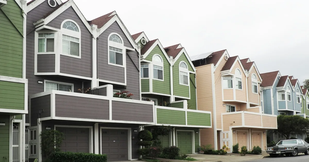 A row of near-identical houses standing side by side on a hill