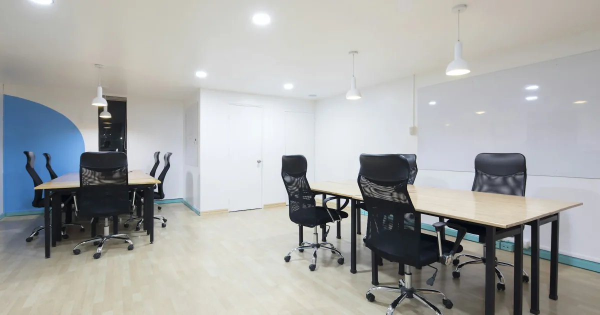 An empty office space with desks standing ready