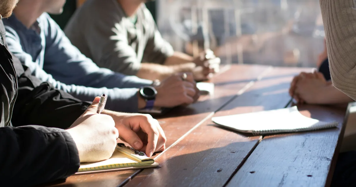 Several people around a table taking notes before a shift
