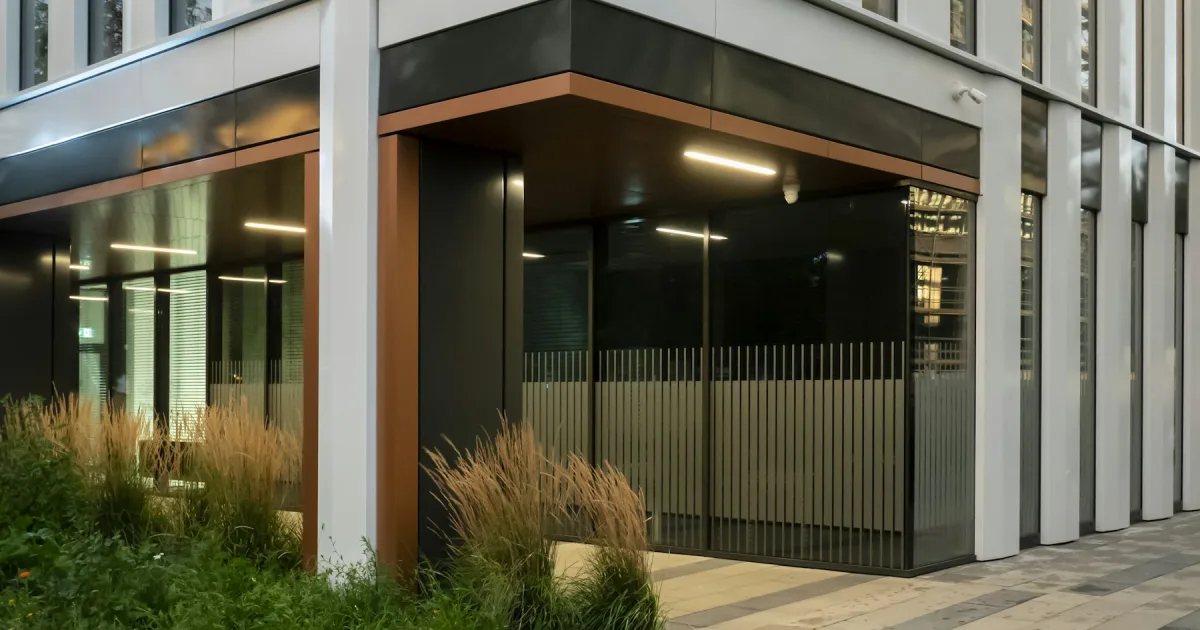 The glass entrance of a modern office building