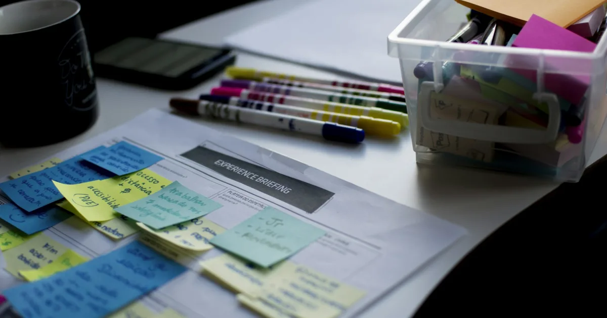 Sticky notes and pens lying on a printed document
