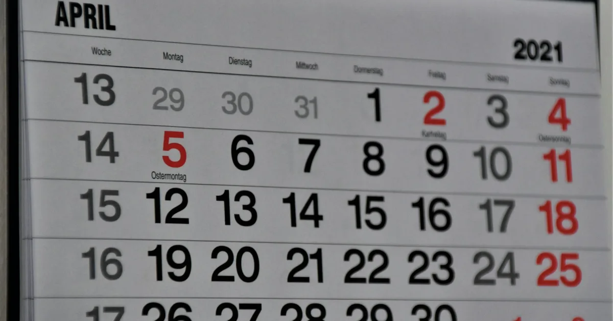 A wall calendar open on a spring month