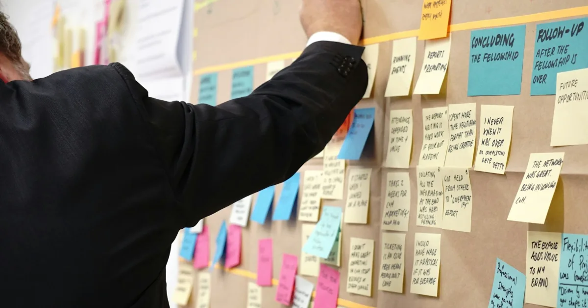 Sticky notes pinned across a corkboard