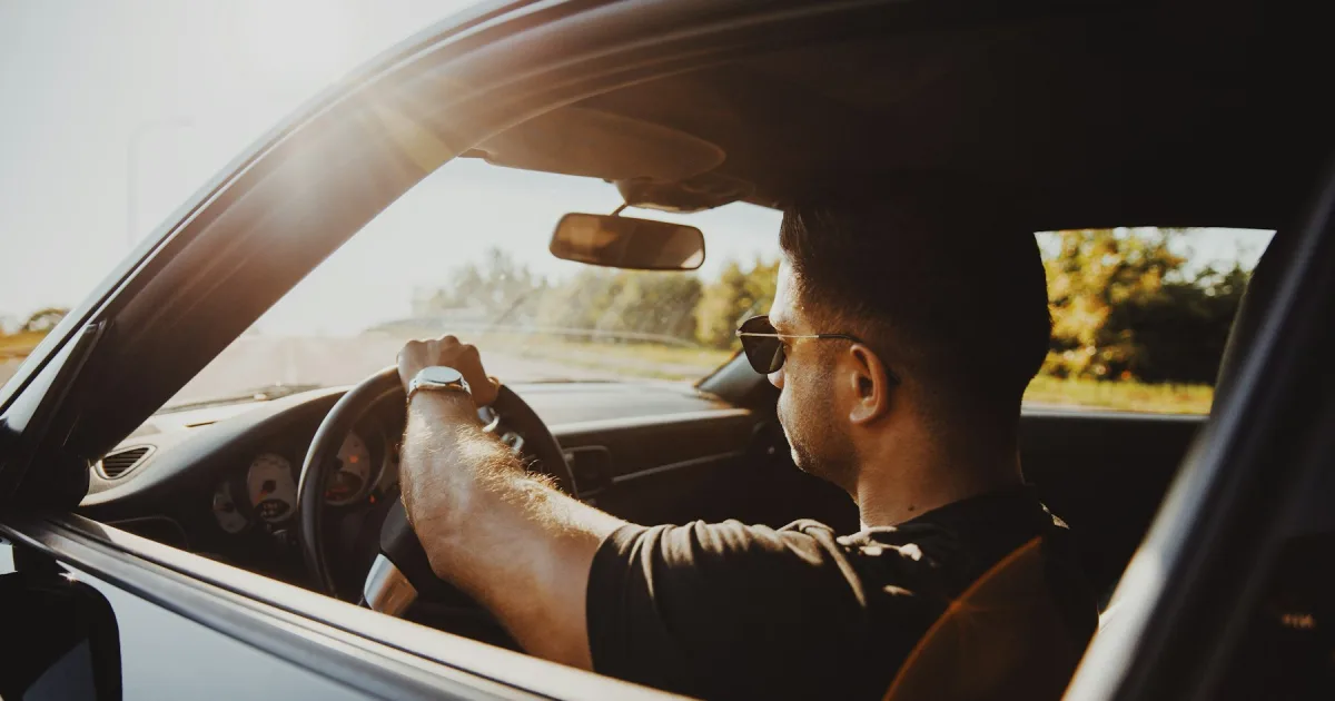 A driver at the wheel, looking ahead through the windscreen